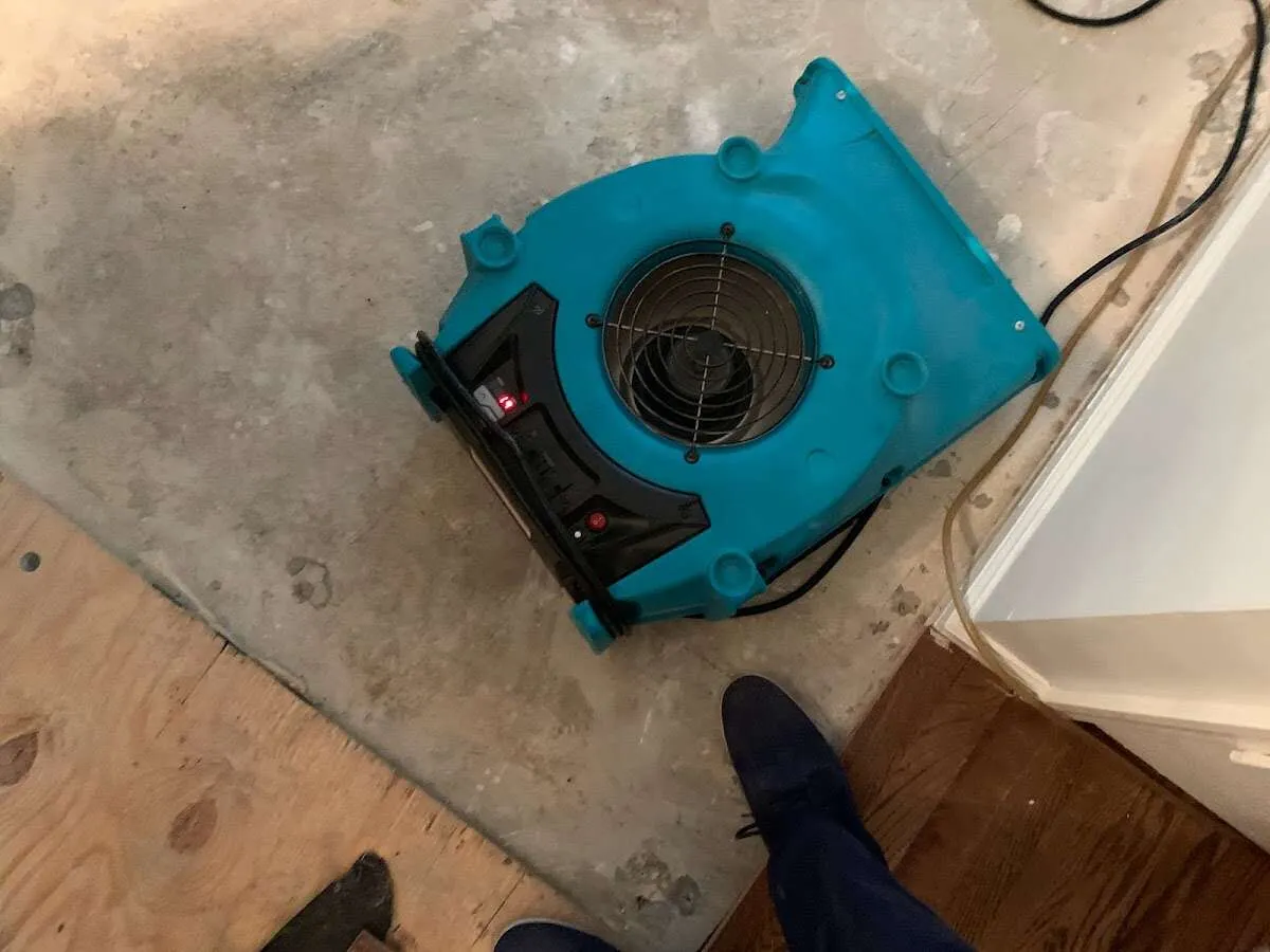 Air mover drying subfloor during Commercial Water Damage Restoration in Knik-Fairview